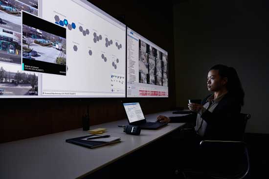 An image of a security person keeping an eye on the video monitors.